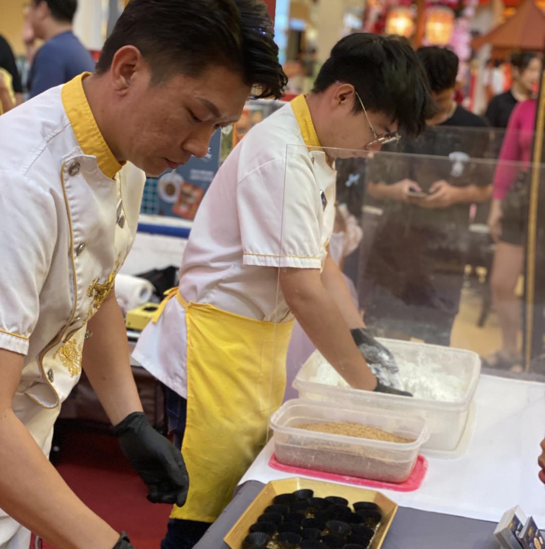 Happy attendees receiving their traditional Dragon Beard Candy giveaway
