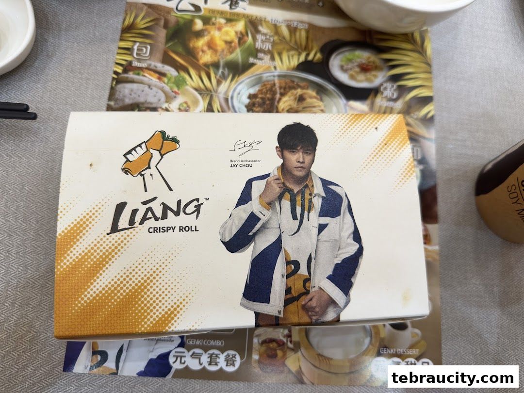 A box of Liang Crispy Roll featuring Jay Chou, with menu items in the background.