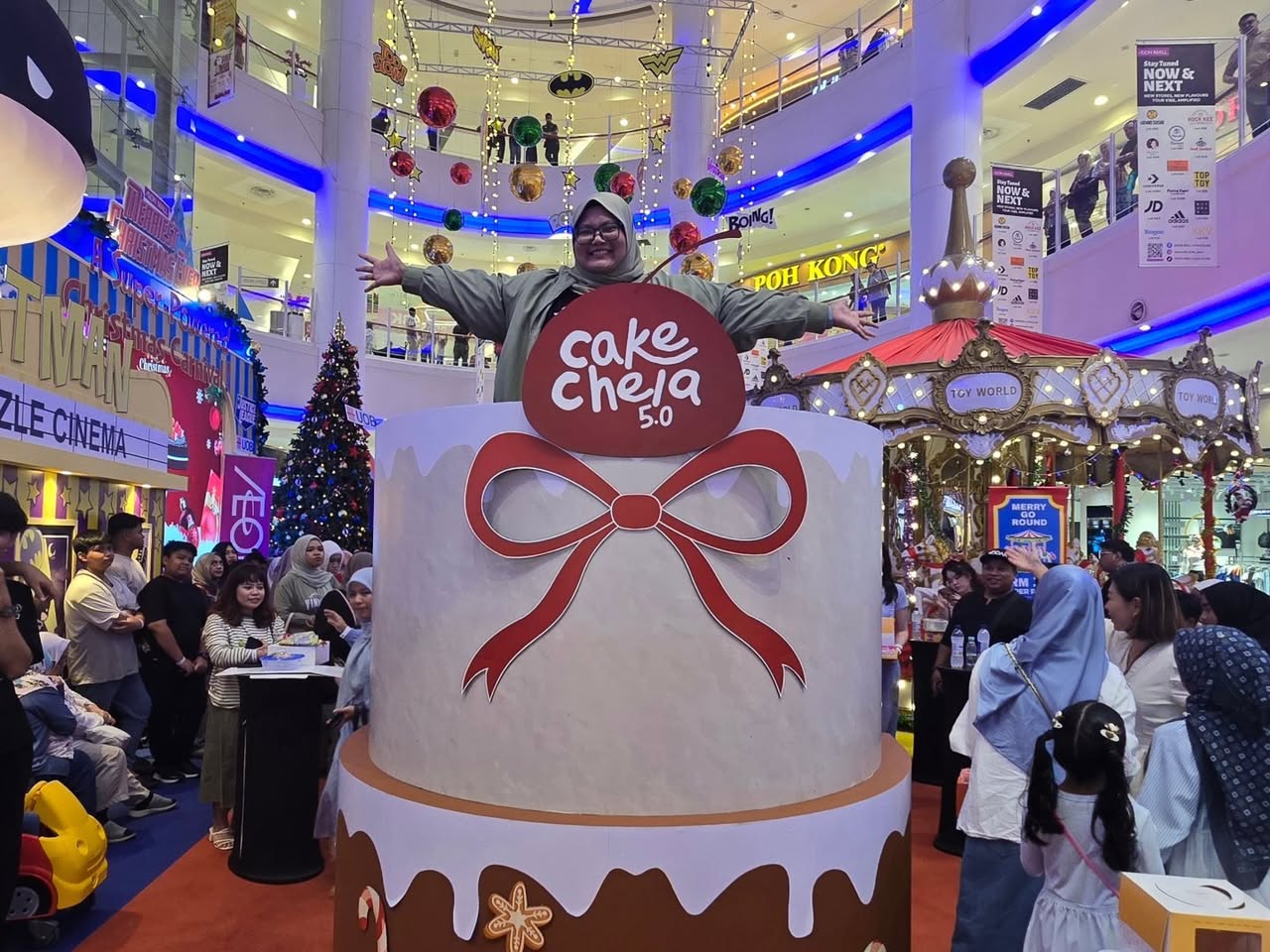 A family posing with a festive 360 degree Christmas centerpiece