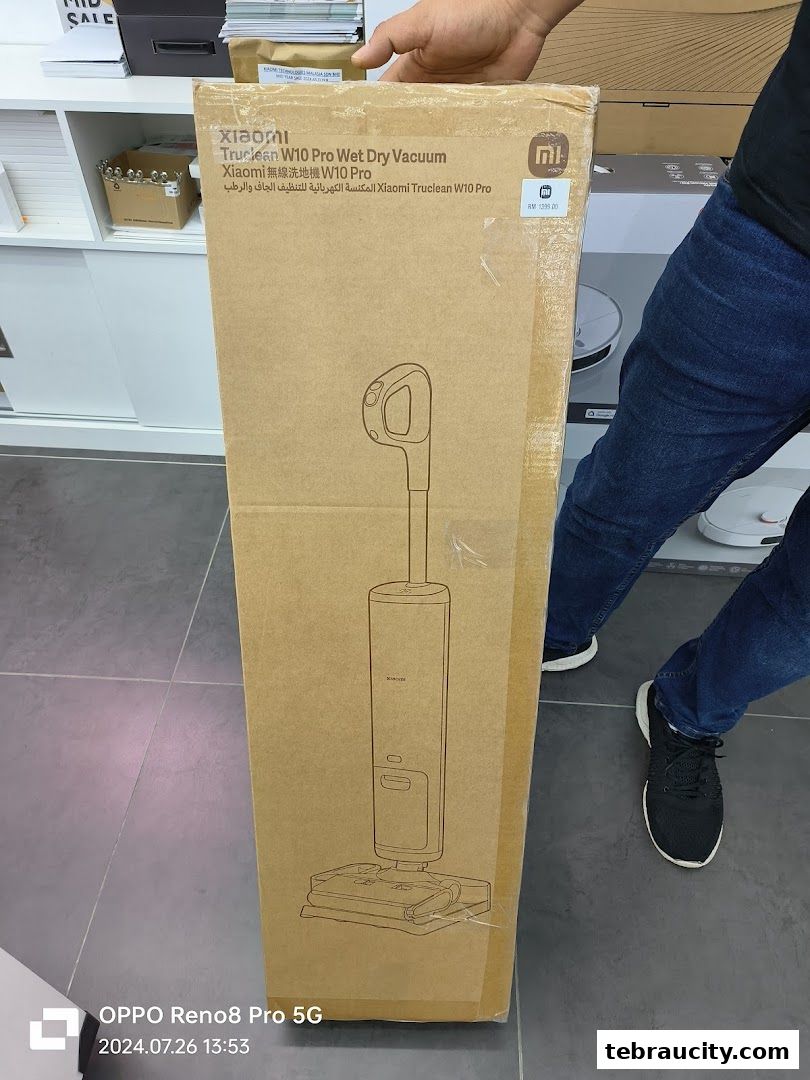 A person holds a box for the Xiaomi Truclean W10 Pro Wet Dry Vacuum.