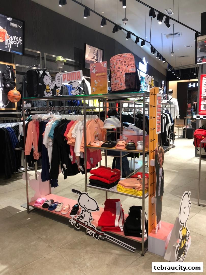 Puma store interior featuring Snoopy-themed apparel and accessories.