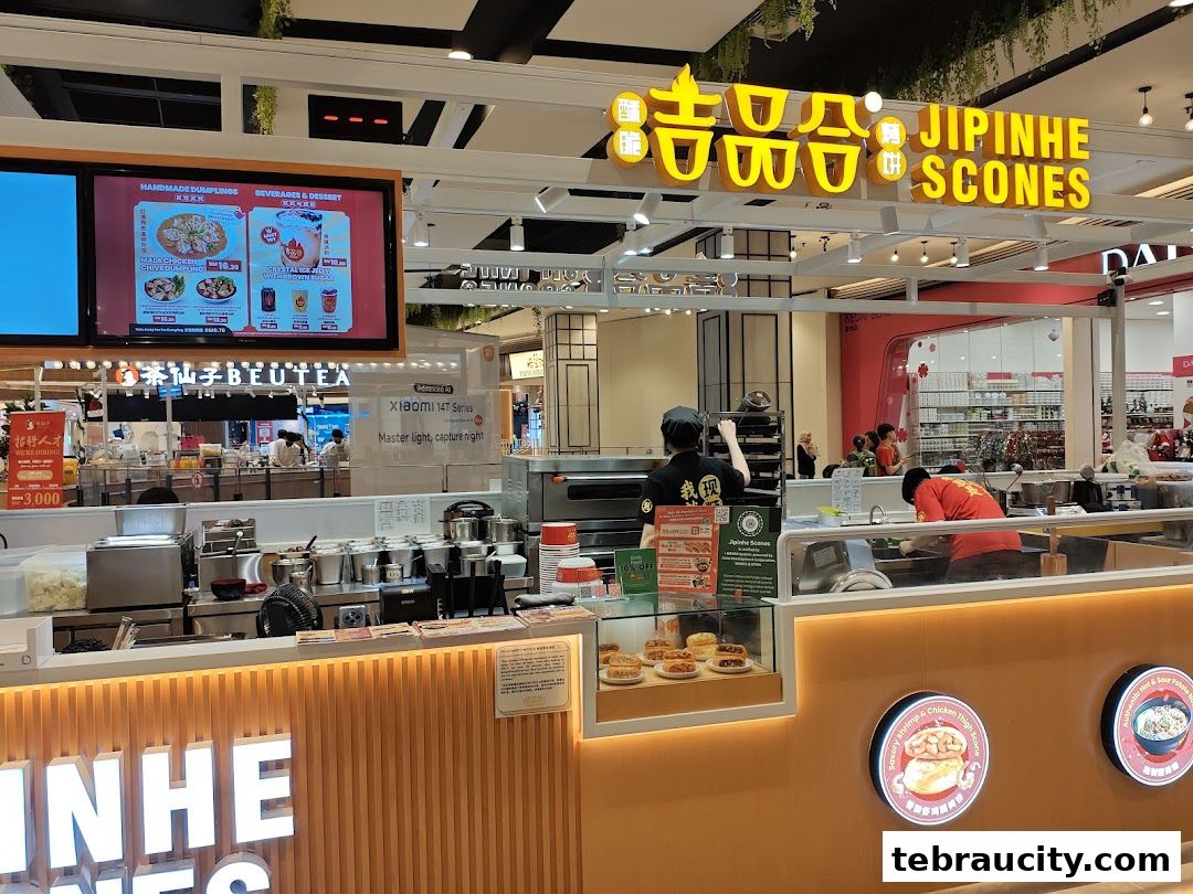 A brightly lit Jipinhe Scones shop with staff preparing food and displaying products.