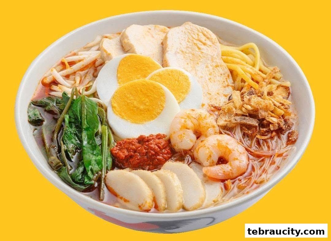 A close-up shot of a delicious bowl of Laksa with prawns, egg, chicken, and vegetables.