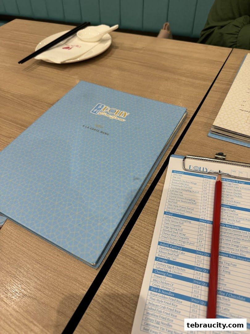A table setting with a Dolly Dim Sum menu and a price list.