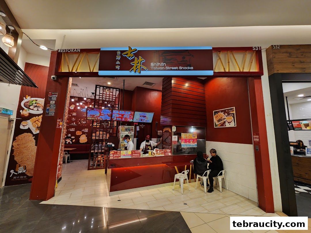 The entrance of Shihlin Taiwan Street Snacks with staff and customers inside.