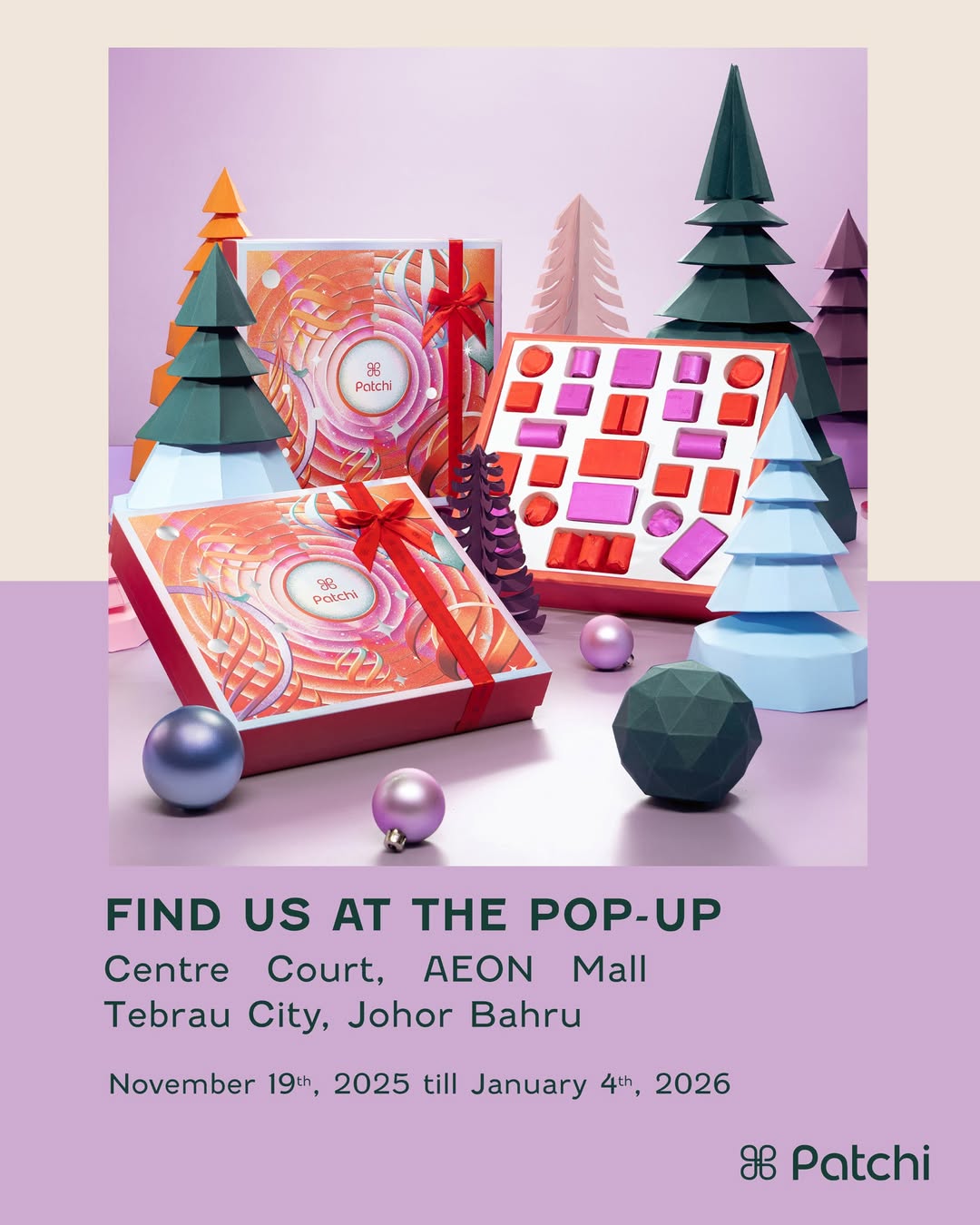 A beautifully arranged display of Patchi chocolates, adorned with festive Christmas decorations, inviting visitors to a sweet celebration.