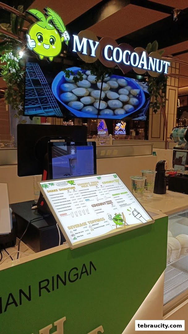 A counter display for My Cocoanut, featuring a menu and a screen showing coconuts.