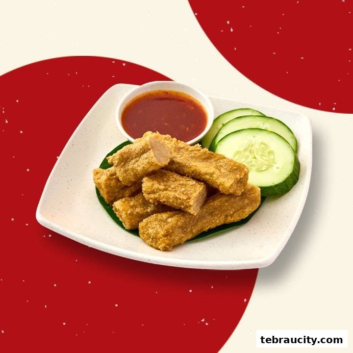 A plate of crispy fried fish cakes served with chili sauce and cucumber slices.