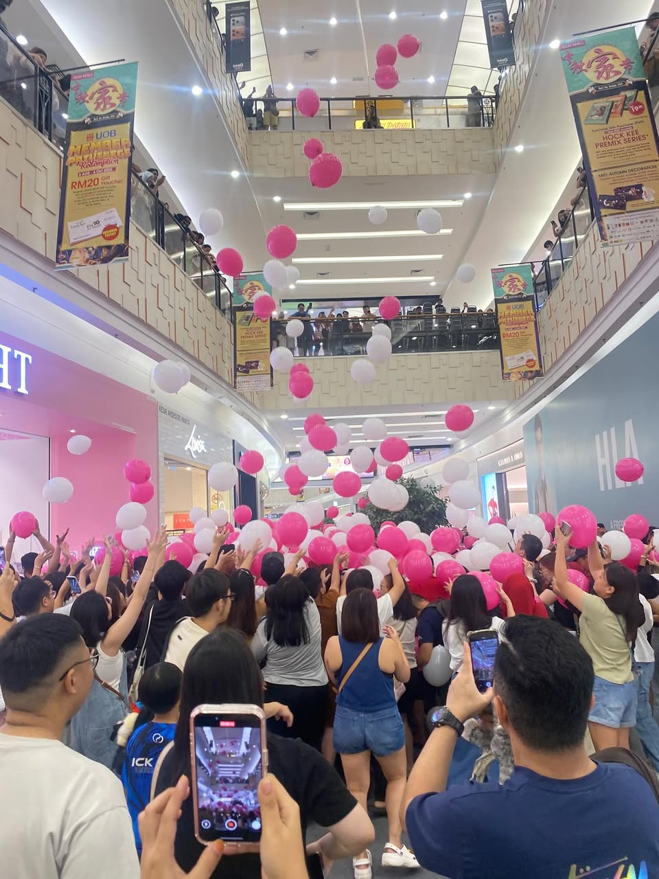 Excited crowd gathering for the Time Out Day Balloon Drop at AEON MALL Tebrau City