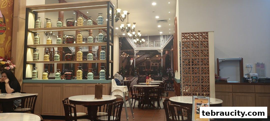 Interior of a Peranakan-themed restaurant with decorative tiffin carriers and seating.