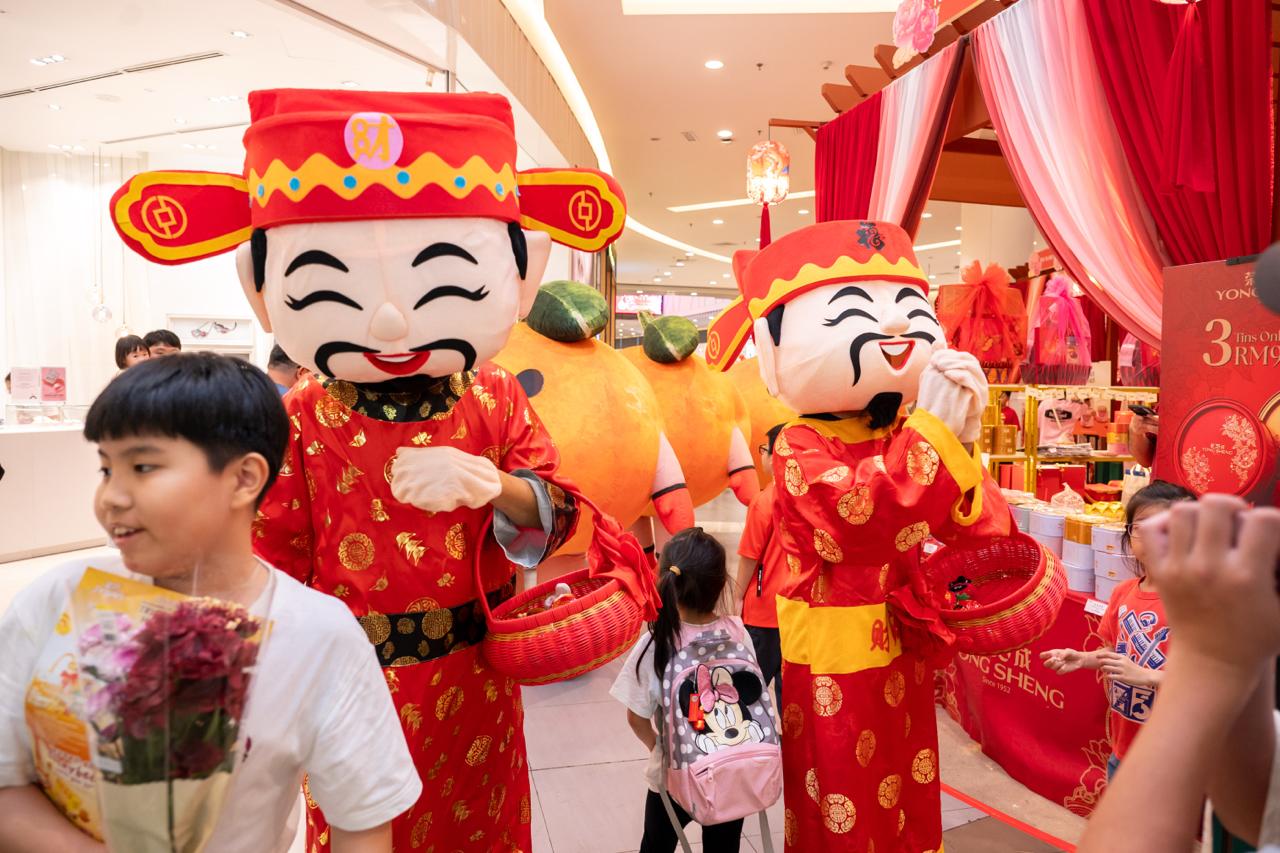 Participants dressed in festive orange attire sharing smiles.