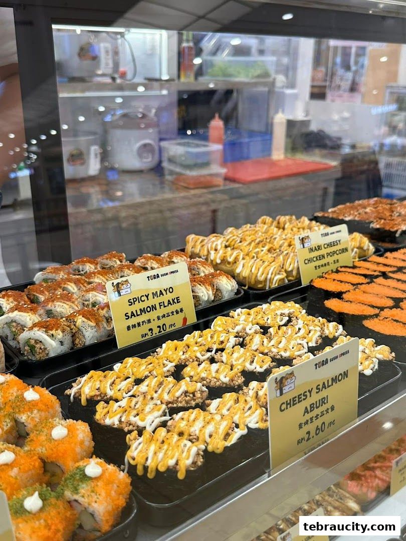 A display of various sushi rolls and nigiri at a sushi shop.
