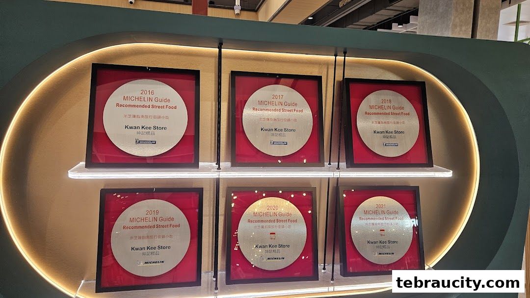 Display of multiple Michelin Guide Recommended Street Food awards for Kwan Kee Store.