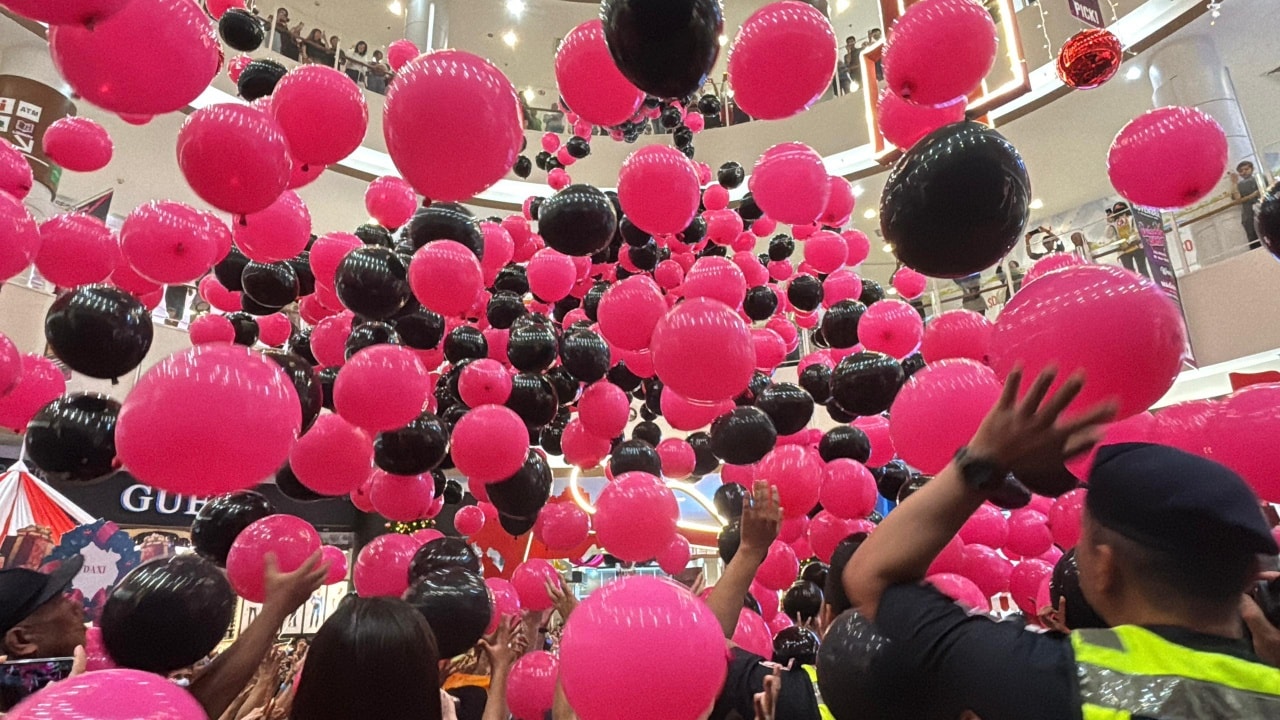 People collecting prizes after the balloon drop
