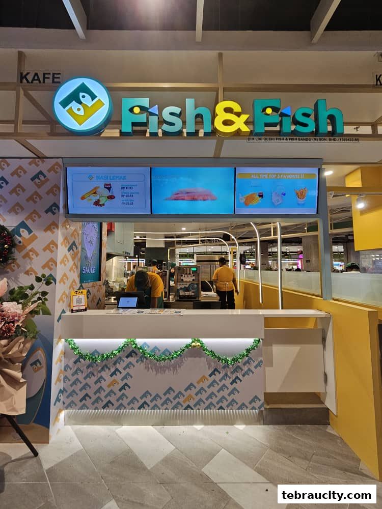 The Fish & Fish cafe counter with digital menus displaying food items and staff behind the counter.