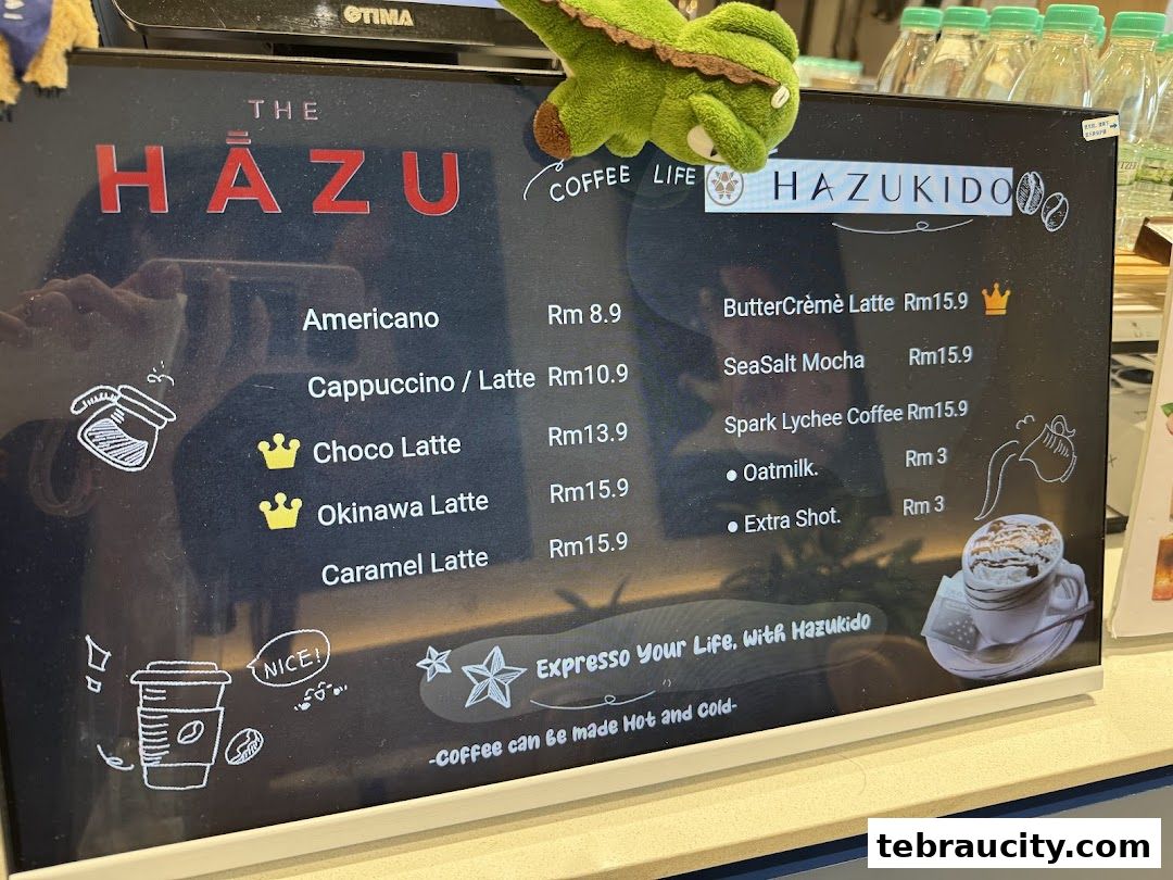 A digital menu board displaying various coffee drinks and their prices at Hazu Bakery Cafe.