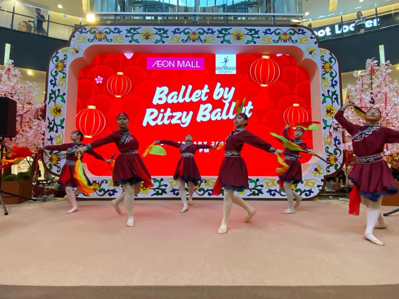 A graceful ballet dancer performing a leap on stage.