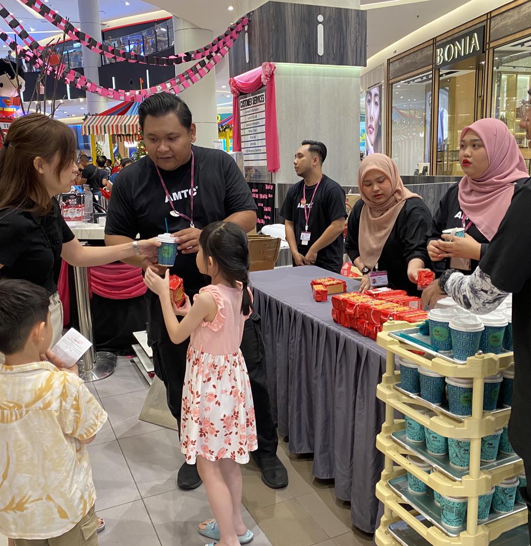 Attendees sharing smiles at the AEON Mall Tebrau City event