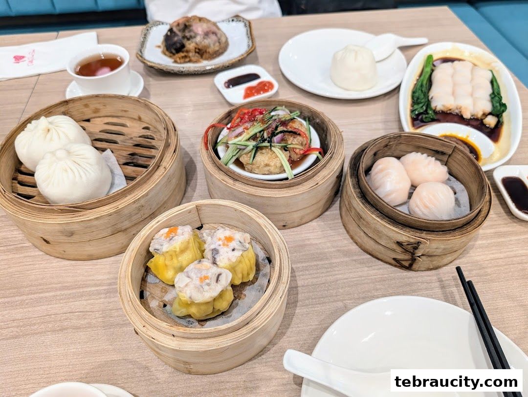 A table filled with various delicious dim sum dishes, including steamed buns and dumplings.