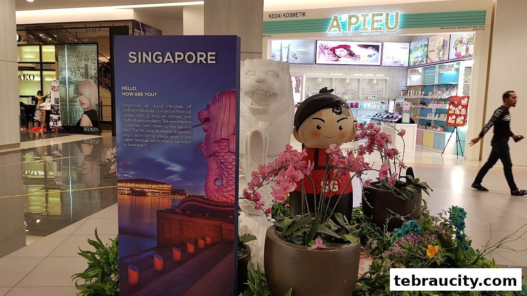 A display featuring Singapore's Merlion and a cultural figure, with a cosmetics shop in the background.