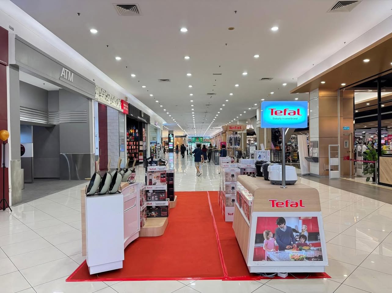 Visitors engaging with TEFAL kitchen appliances at the event.