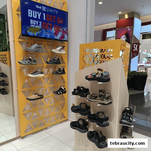 A display of Teva brand sandals and shoes, with a promotional screen showing discounts.