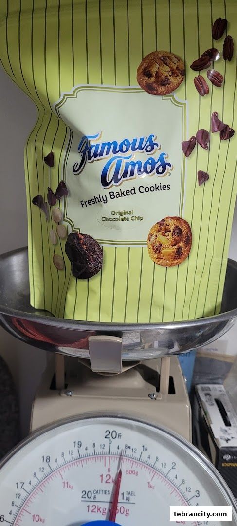 A bag of Famous Amos Original Chocolate Chip cookies is weighed on a scale.
