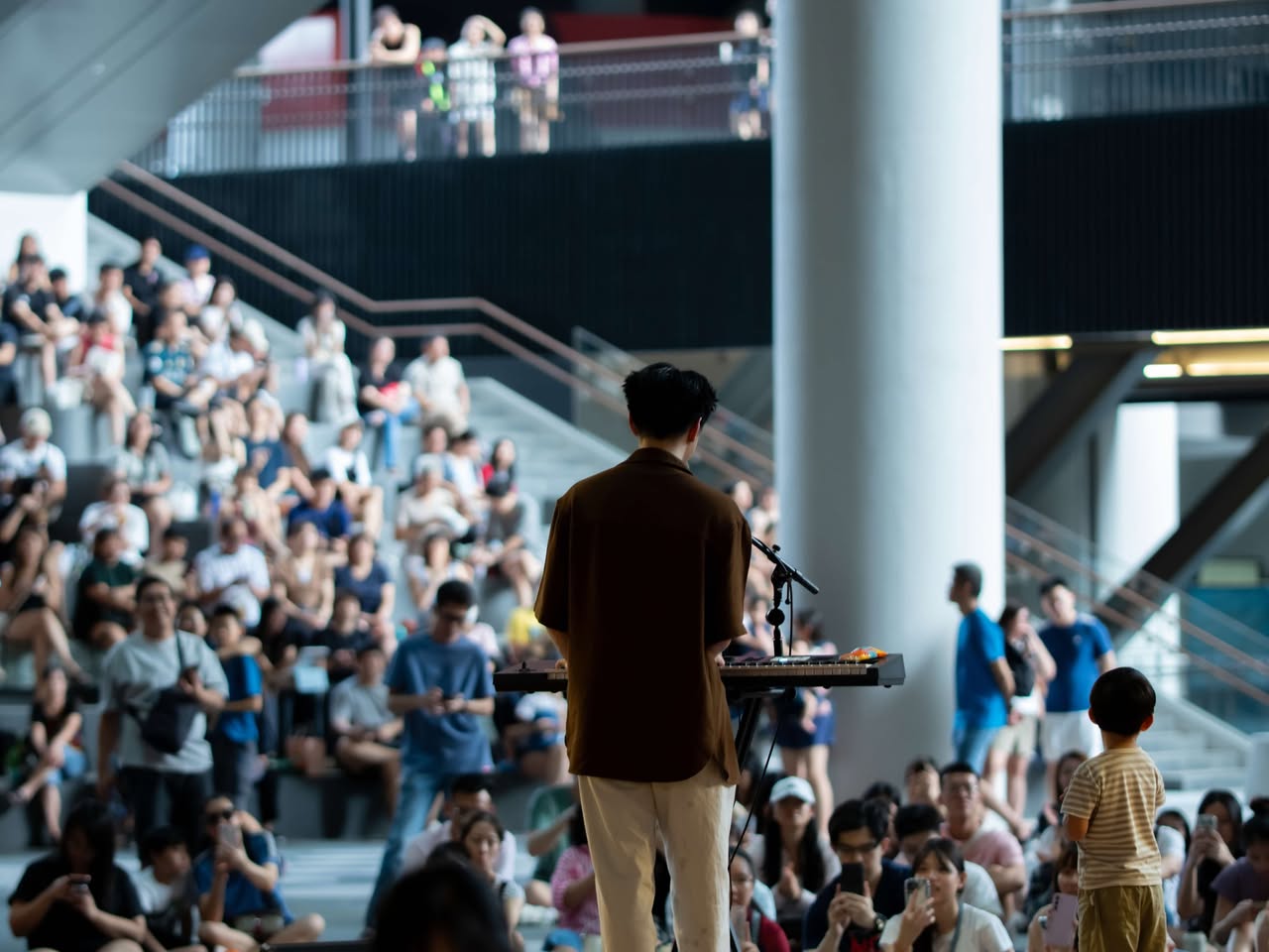 Jeff Ng performing for a large crowd at the Nexus during WonderLab