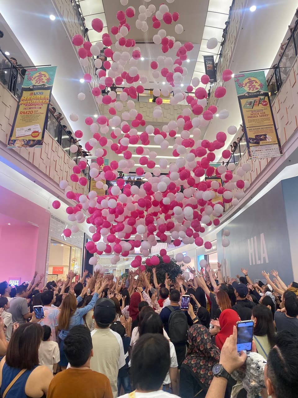 Hundreds of balloons descending during the Time Out Day event at AEON MALL Tebrau City