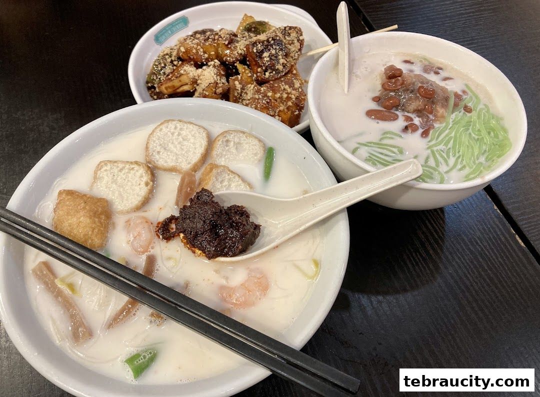 Three bowls of Malaysian desserts and snacks, including Chendol and a savory noodle dish.