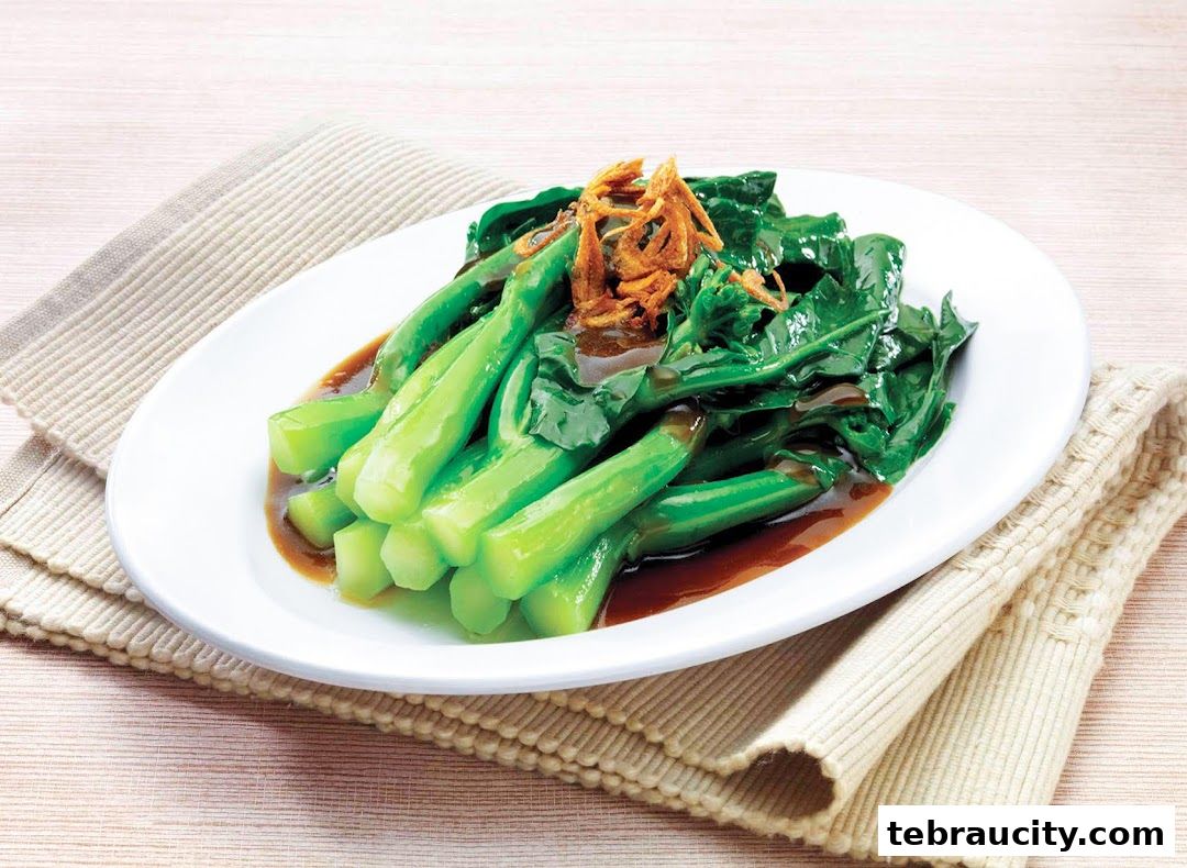 A plate of stir-fried Chinese broccoli with oyster sauce and fried shallots.