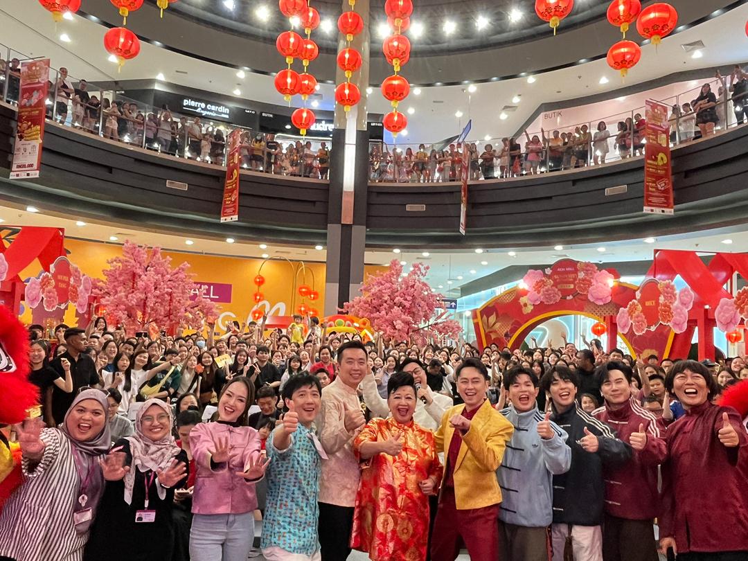 Festive decorations and shoppers enjoying the Prosperity Blossom theme