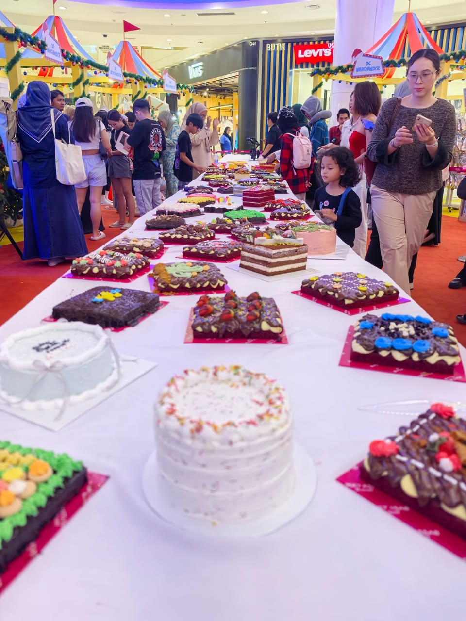 Families and friends sharing a meal at the Christmas picnic.
