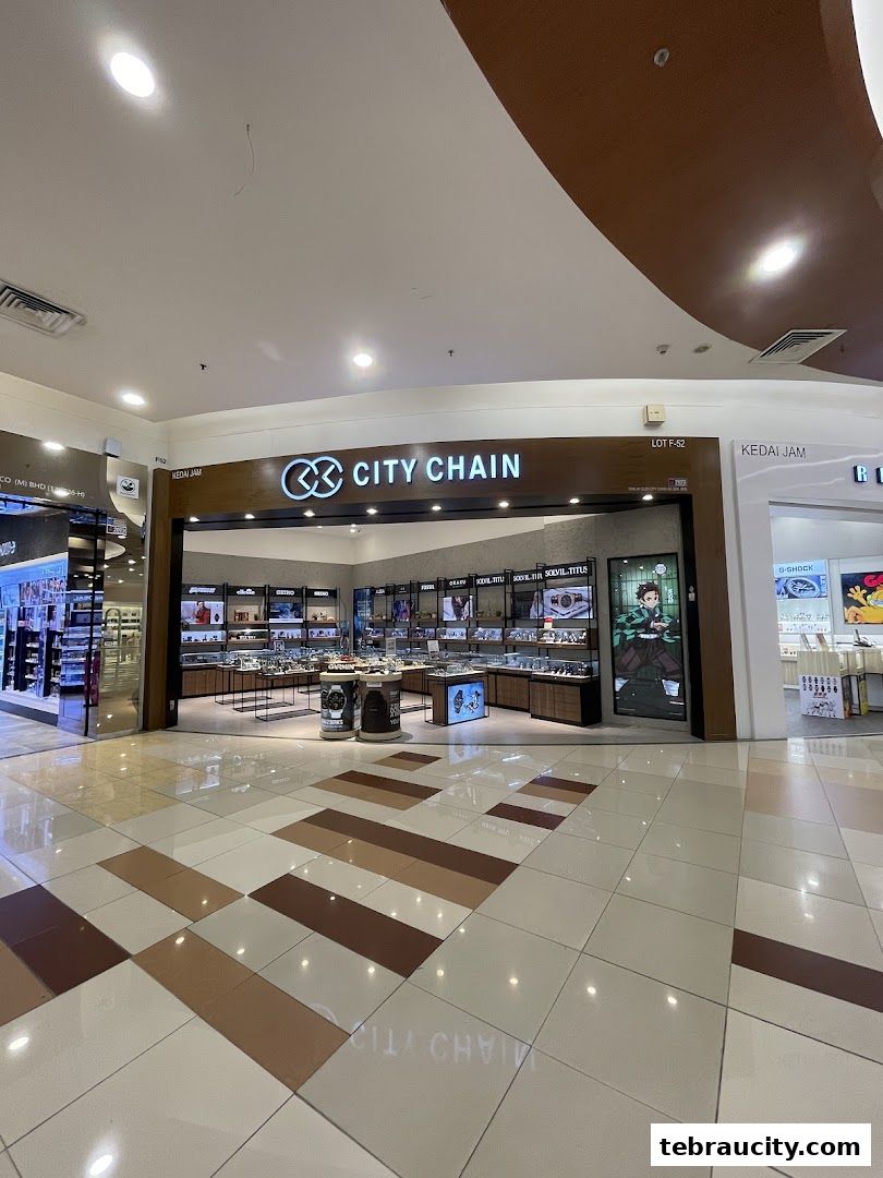 The City Chain watch store entrance with displays of watches and a promotional poster.
