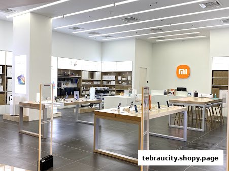 Interior view of a modern Xiaomi store showcasing various electronic products on display tables.