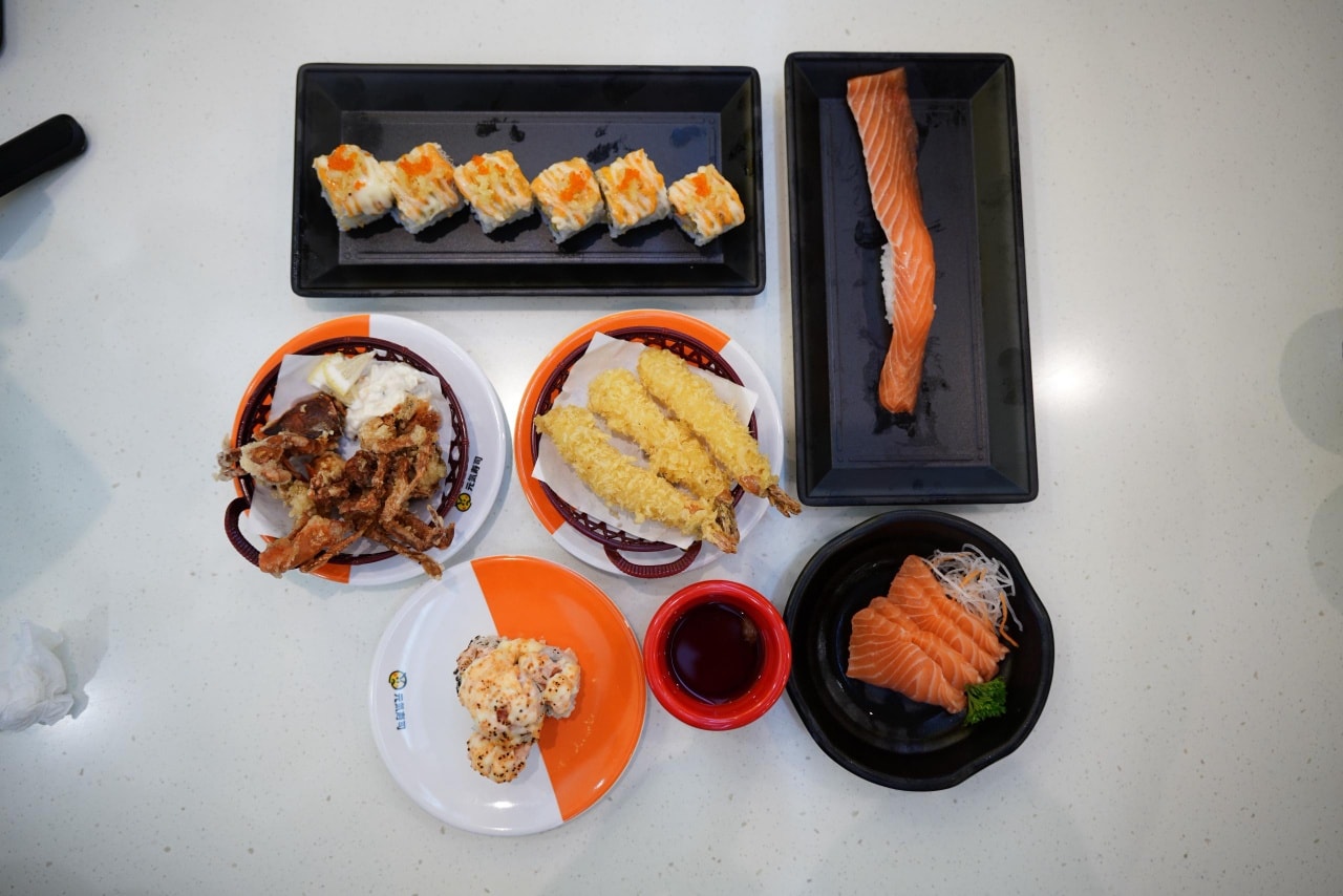 Assortment of fresh sushi platters on a conveyor belt