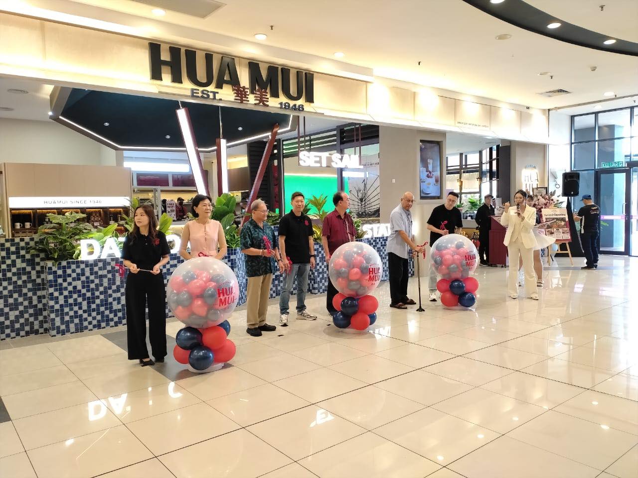 A close-up of the festive decorations and branding at the grand opening.