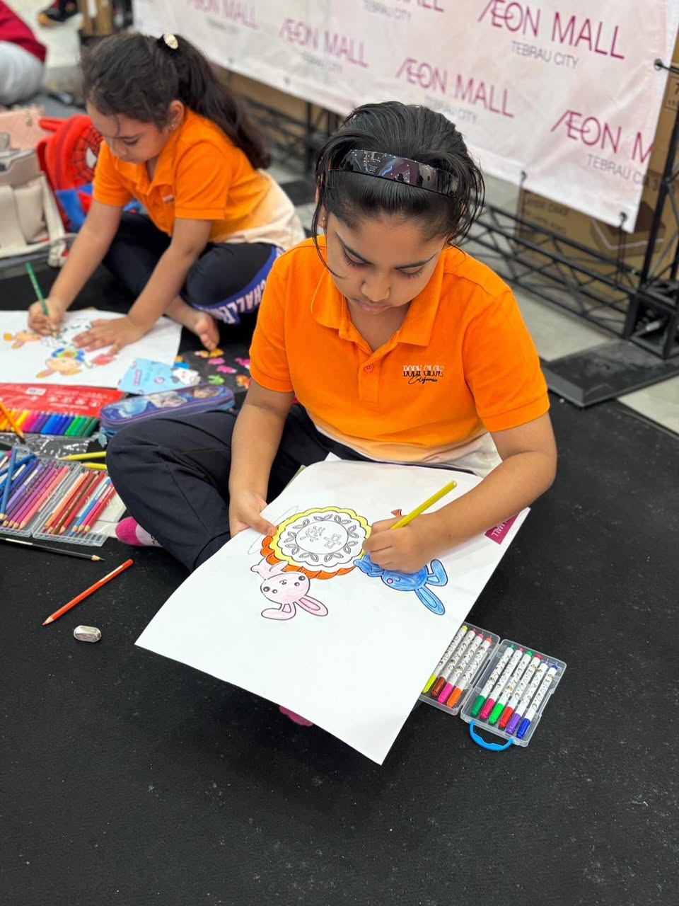 Concentrated young artists busy coloring during the festival event