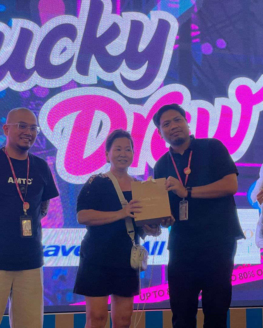 A lucky winner proudly displaying their prize