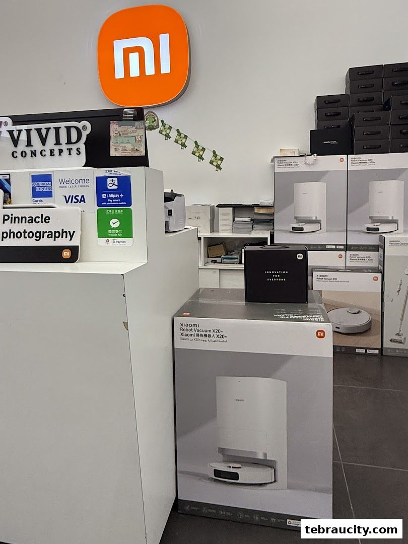 Interior of a Xiaomi store showcasing robot vacuums and payment options.