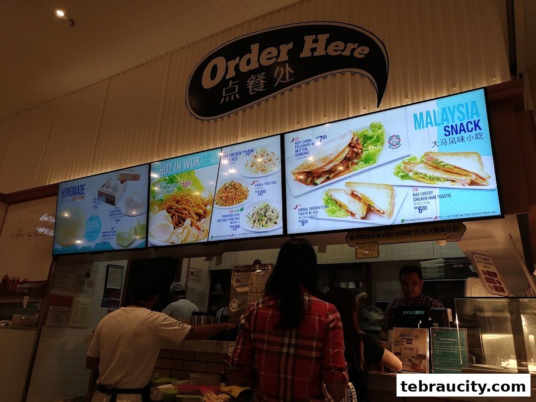 A digital menu board displaying various food items and prices at a restaurant.