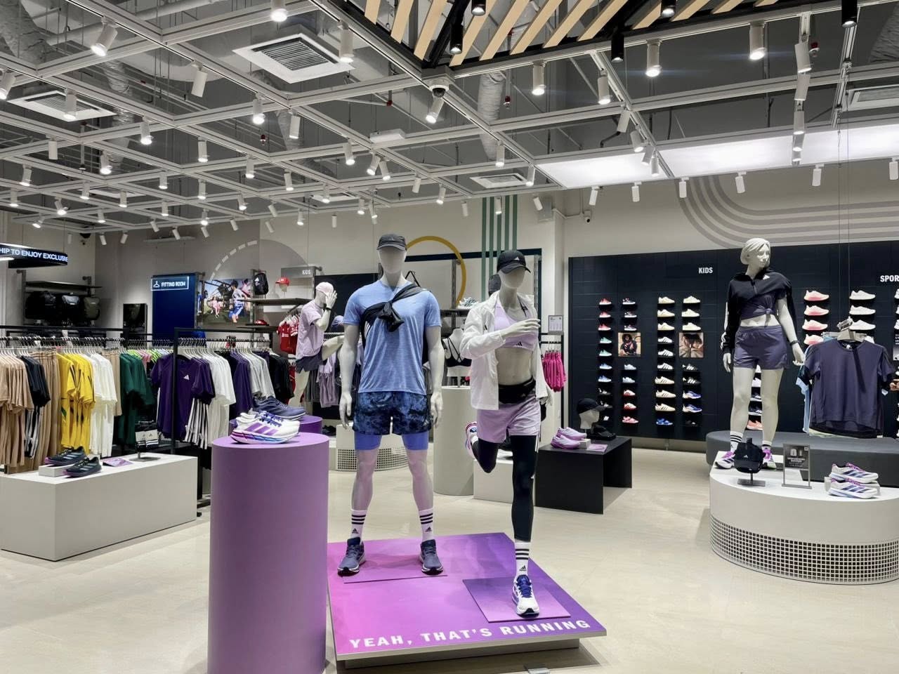 Sportswear display featuring training gear and accessories at the new Adidas store