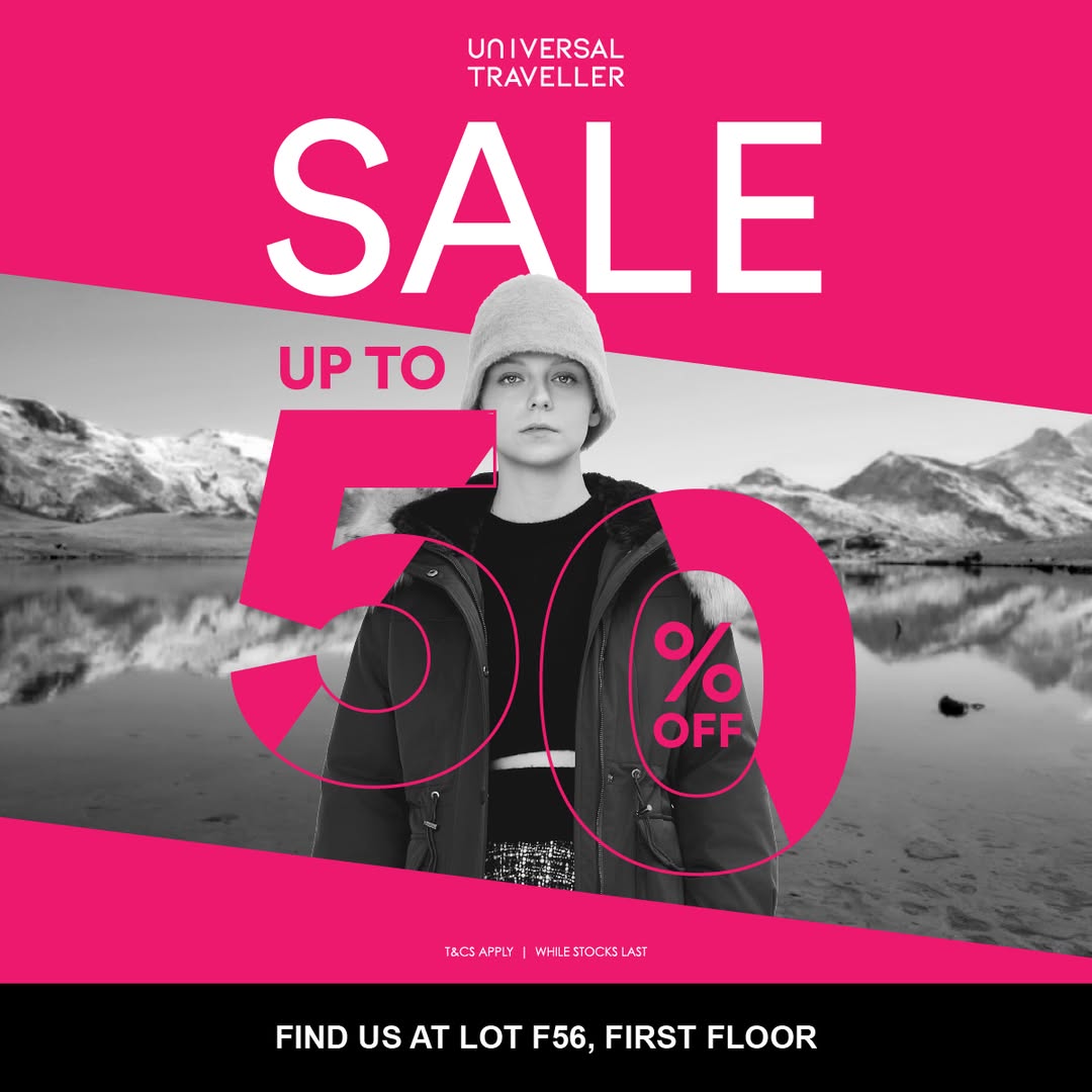 A display of winter wear, luggage, and travel accessories on sale at Universal Traveller.