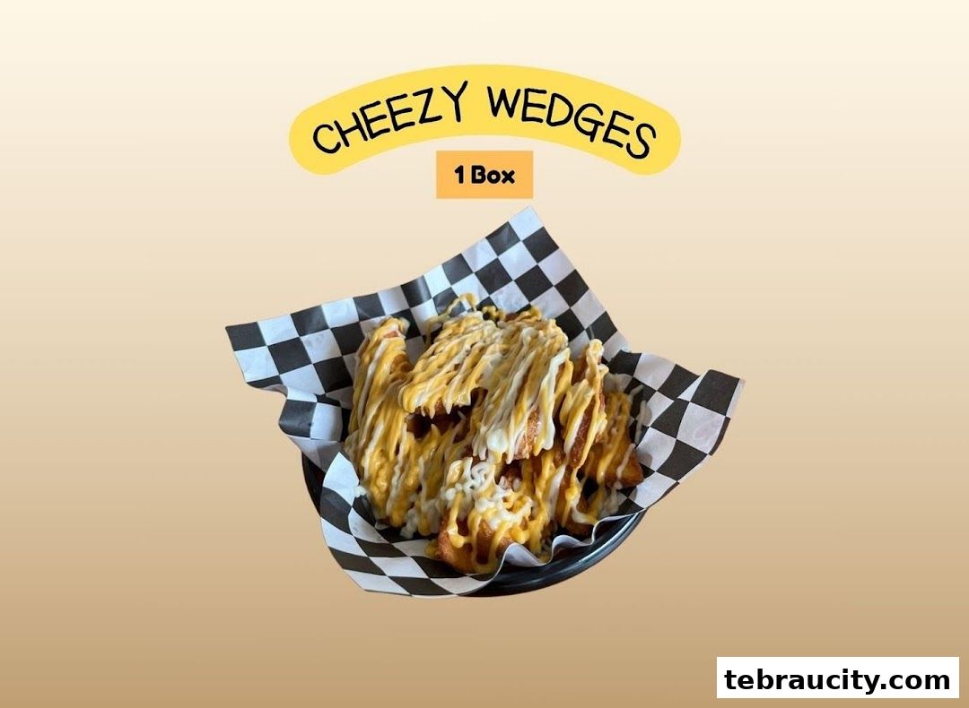 A basket of Cheezy Wedges drizzled with cheese sauce.