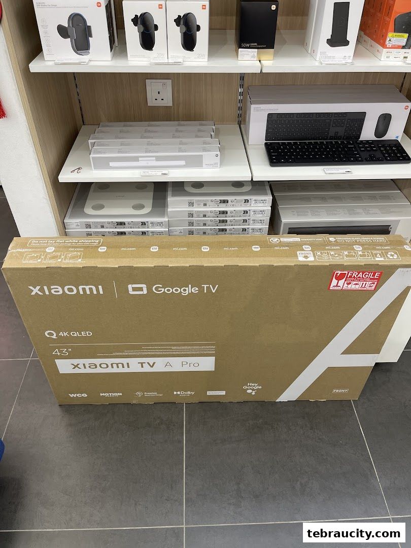 A Xiaomi TV box and other Xiaomi products displayed on shelves in a store.