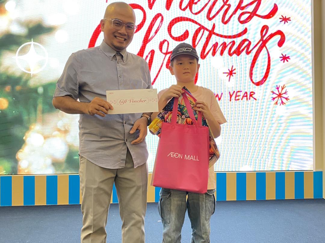 Families gathered around tables, engaged in the Christmas coloring activity
