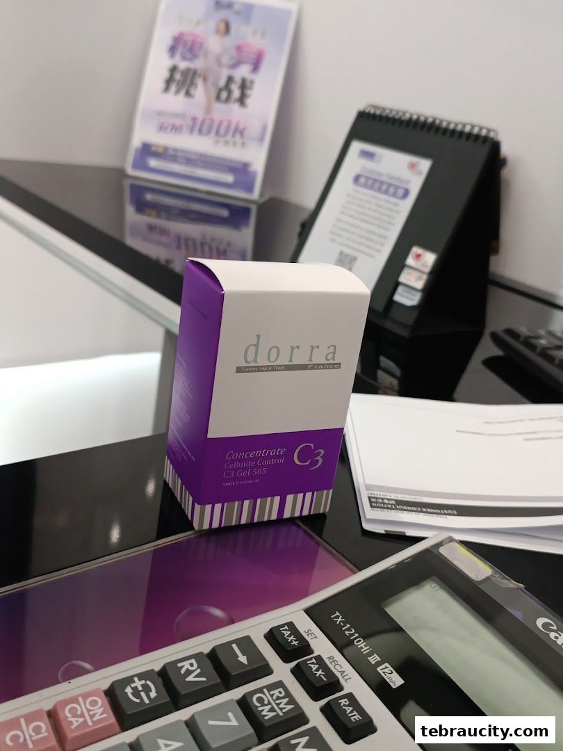 A Dorra slimming product box sits on a desk with a calculator and promotional materials.