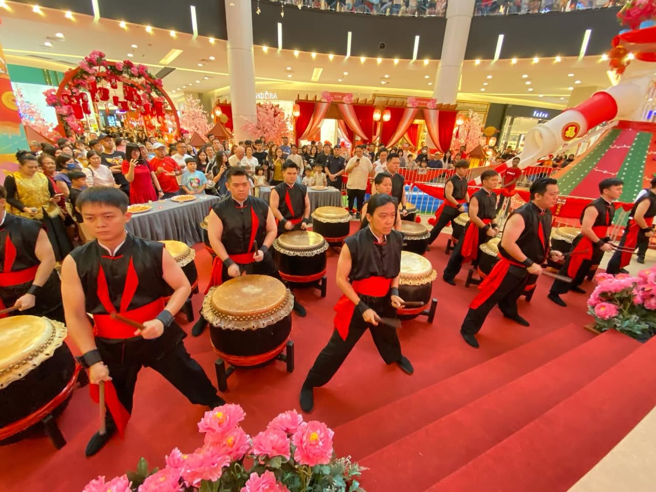 Drummers in synchronized motion during the cultural celebration.