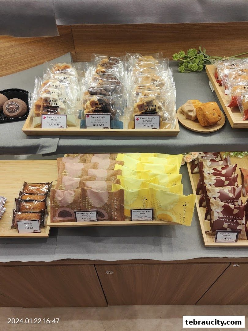 A display of individually packaged pastries and biscuits in a retail shop.