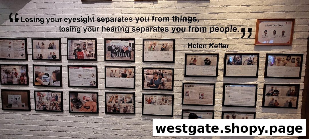 A white brick wall displays a Helen Keller quote about hearing, surrounded by framed photos of the team and customers.